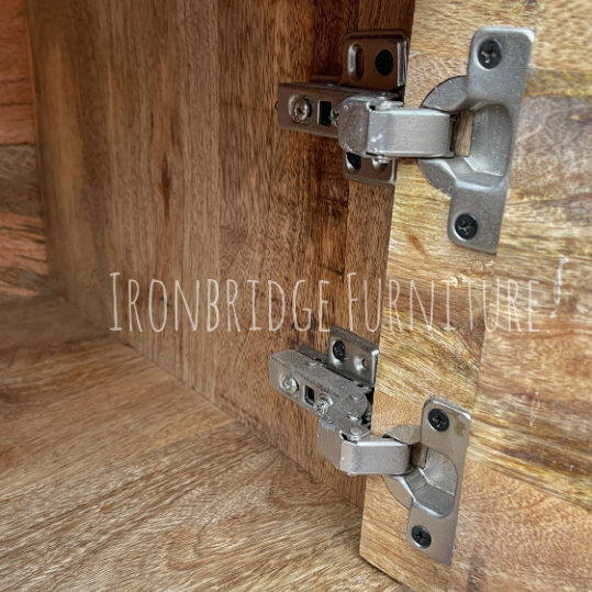 Metal cabinet hinges on wooden furniture with 'Ironbridge Furniture' branding.