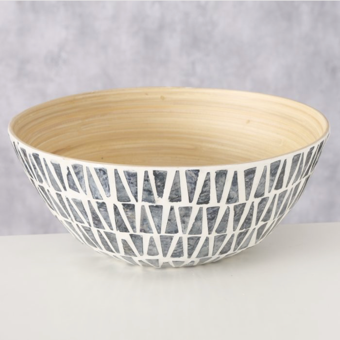 Ceramic bowl with geometric pattern on a gray background