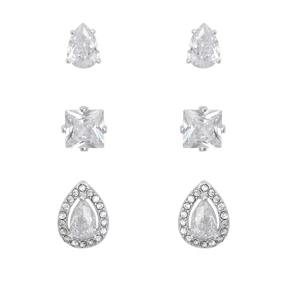 Set of silver earrings with clear gemstones on a white background
