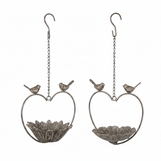 Two heart-shaped bird feeders with small birds on a white background