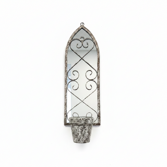 Decorative wall-mounted metal planter with a mirror on a white wall