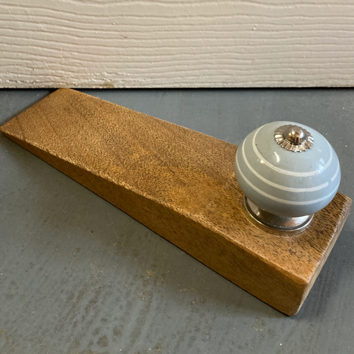 Mango wood door stop wedge. With or without ceramic knob handle. Against the door. 