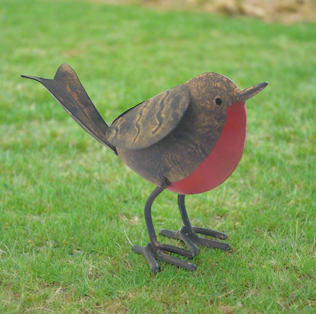 Tin robin garden ornament on grass