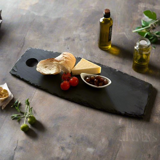 oval slate chopping board with cheese and bread