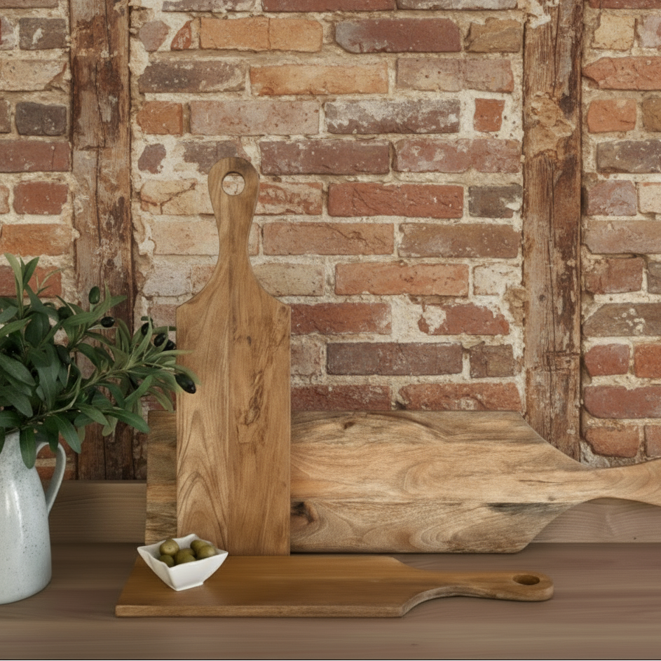 Wooden cutting boards on a kitchen counter with a modern kitchen in the background