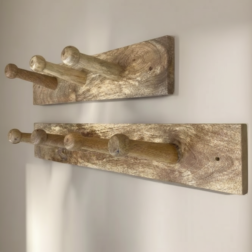Two wooden wall hooks with four pegs on a plain background