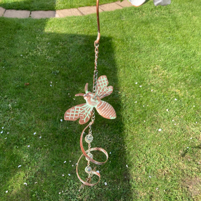 Decorative wind chime shaped like a dragonfly on grass