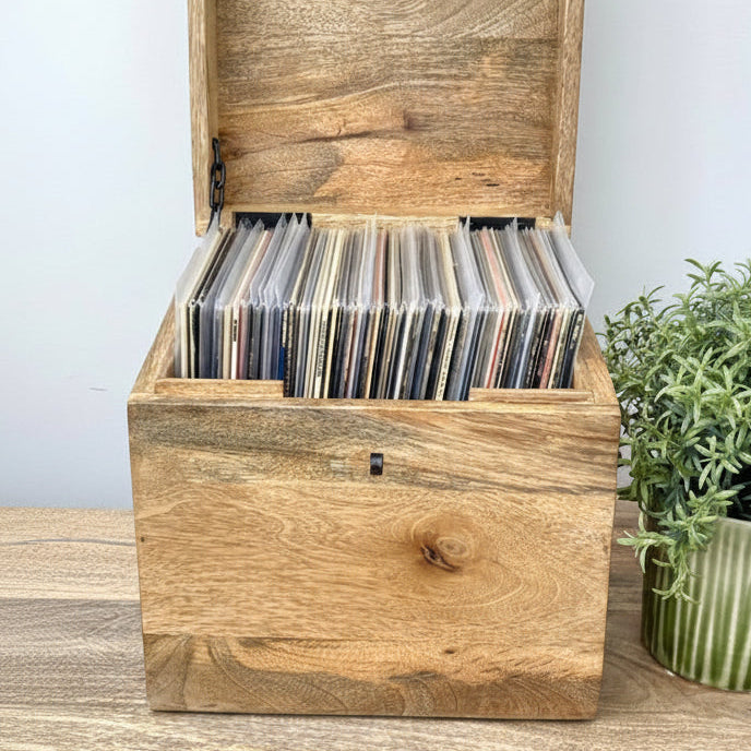 Wooden box with a plant on a gray background