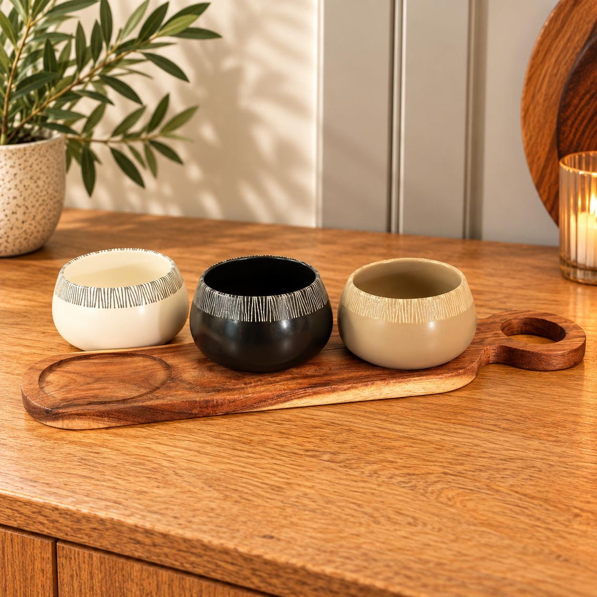 Set of 3 tapas bowls on an Acacia wood serving paddle.