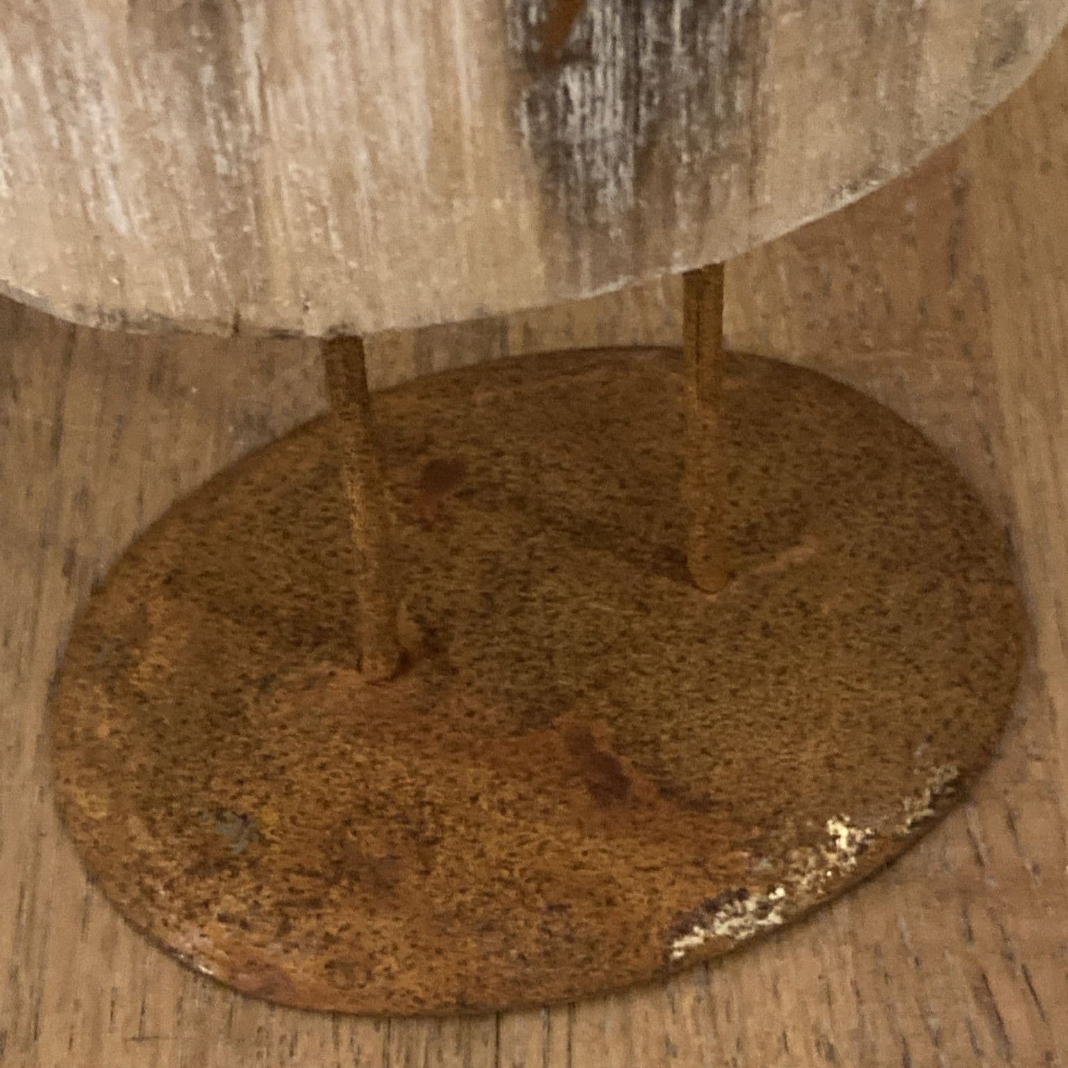 Floor standing reindeer decoration - wood with metal detail - close up of base.