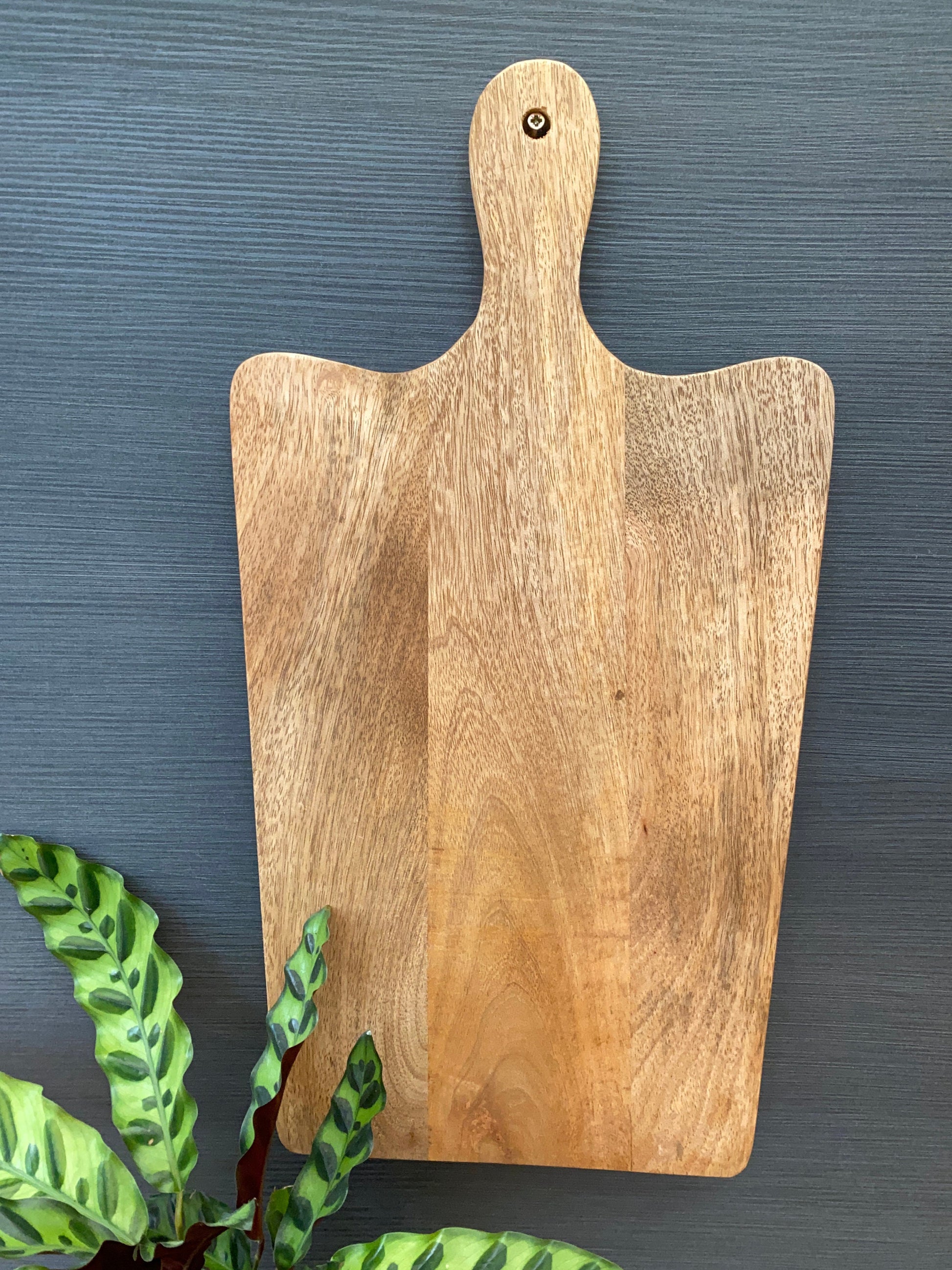 Solid Mango wood food serving paddle boards - Available in 3 sizes. Board hanging on wall for easy storage.