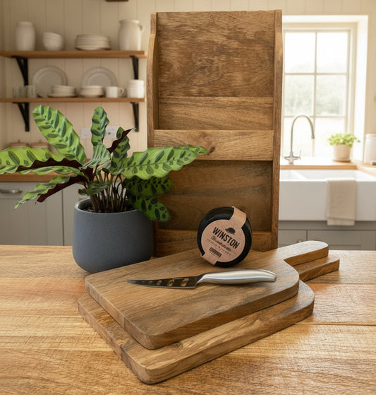 Set/2 Mango wood chopping boards with wall mountable holder. Shown with cheese and a knife.