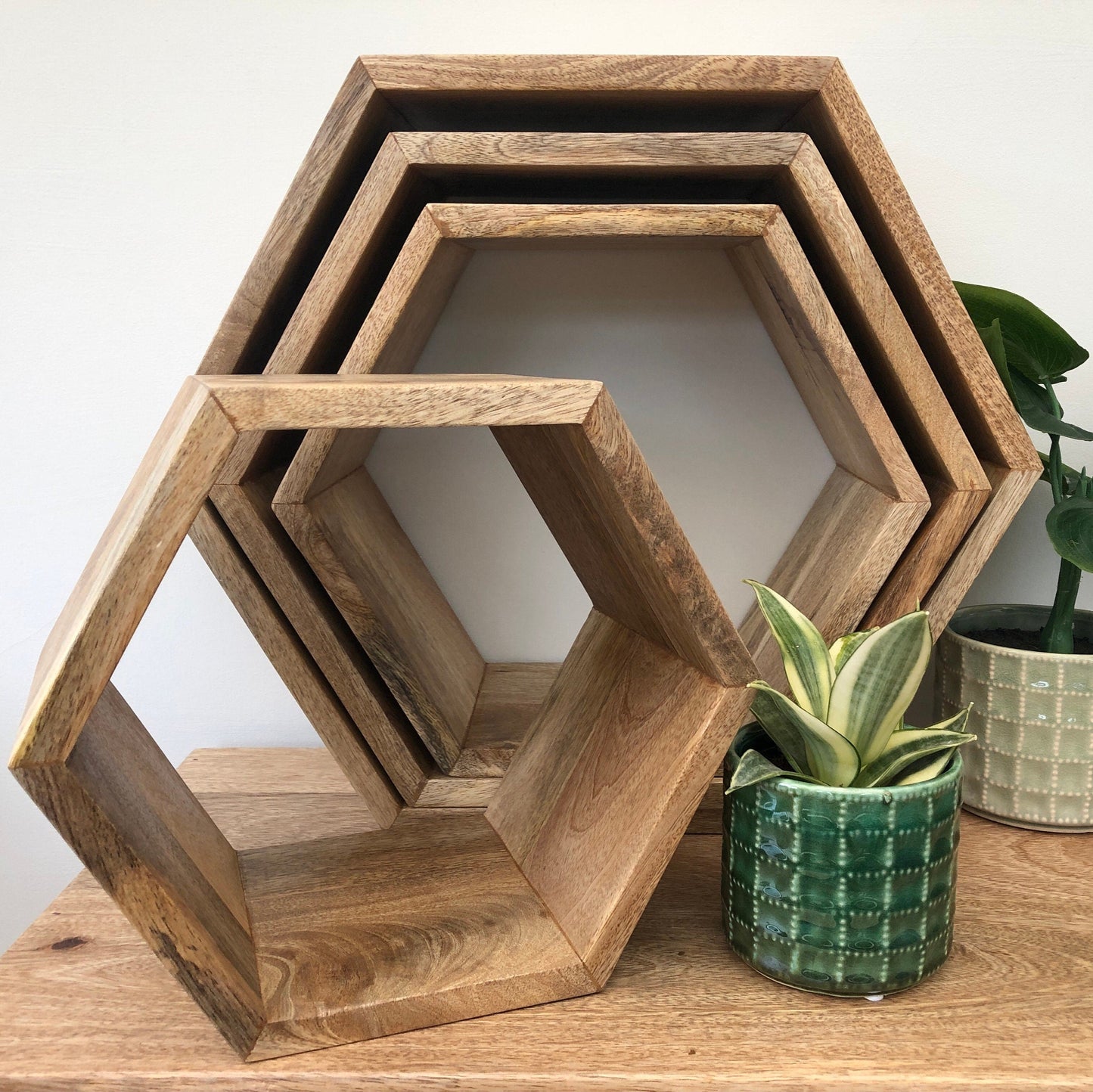 Hexagonal Mango wood floating wall shelves. Group shot of available sizes.