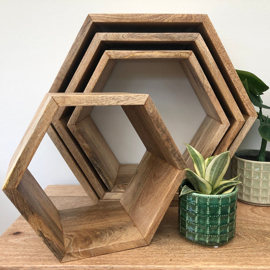 Hexagonal Mango wood floating wall shelves. Group shot of available sizes.