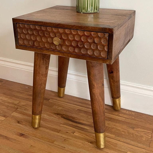 Dark Mango wood side table with 1 carved drawer and tapered legs.