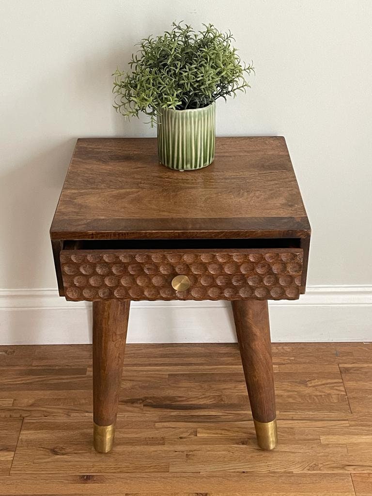 Dark Mango wood side table with 1 carved drawer and tapered legs. Open drawer.