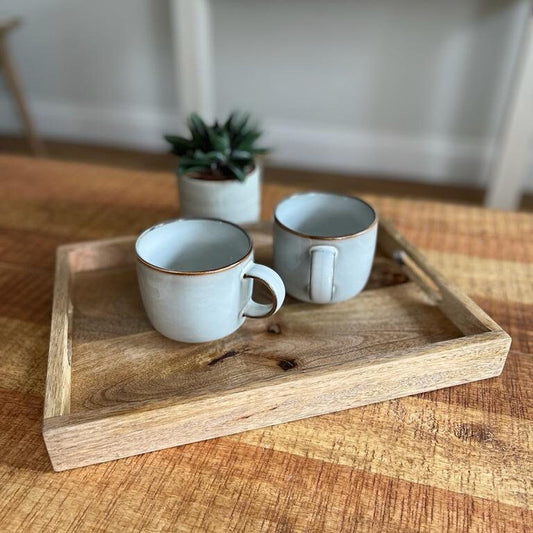 Mango wood straight edge tray with cut out handles. 35x25x4cm shown as a tea tray