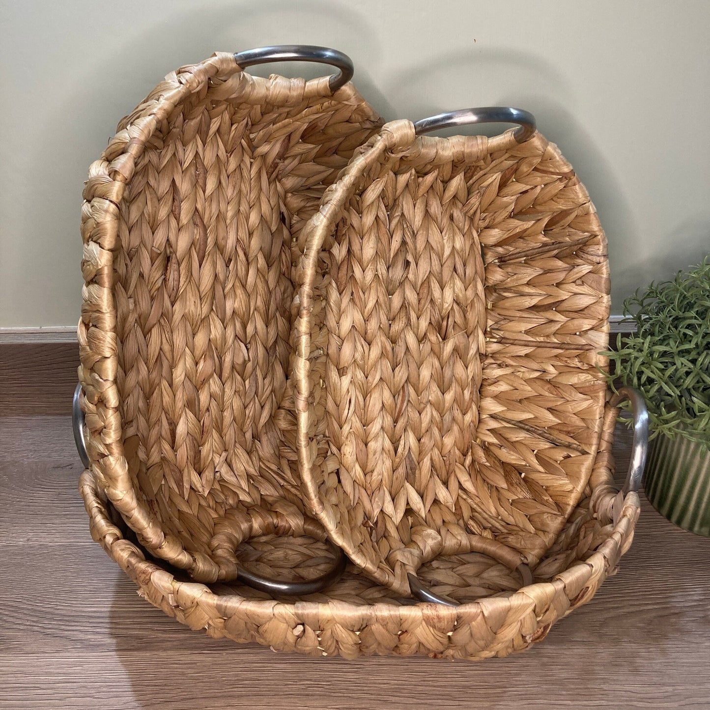 Woven water hyacinth fruit baskets with aluminium loop handles. 2 smaller baskets stood in larger basket.