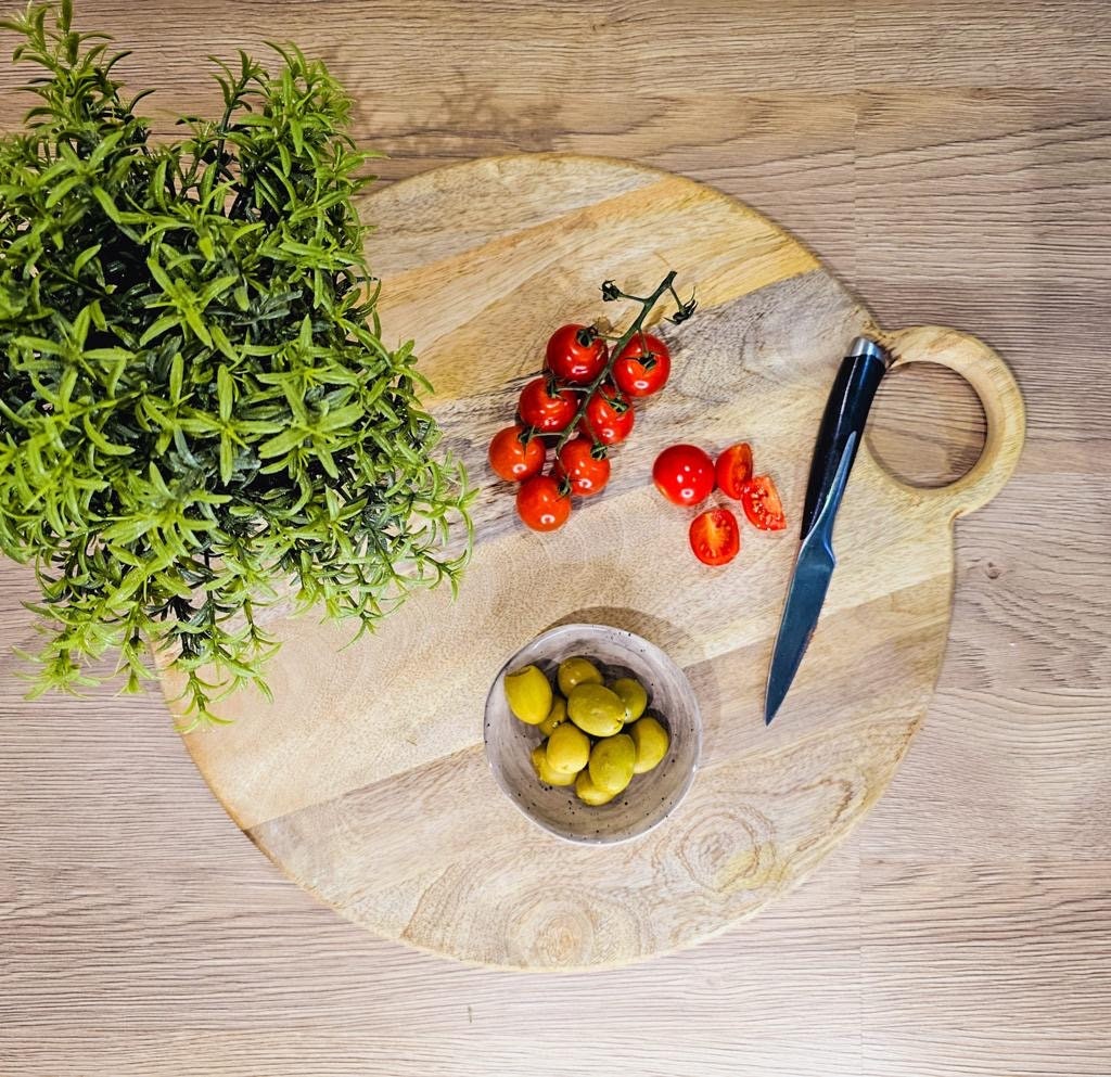 Round loop handled food boards made from solid Mango wood. from above