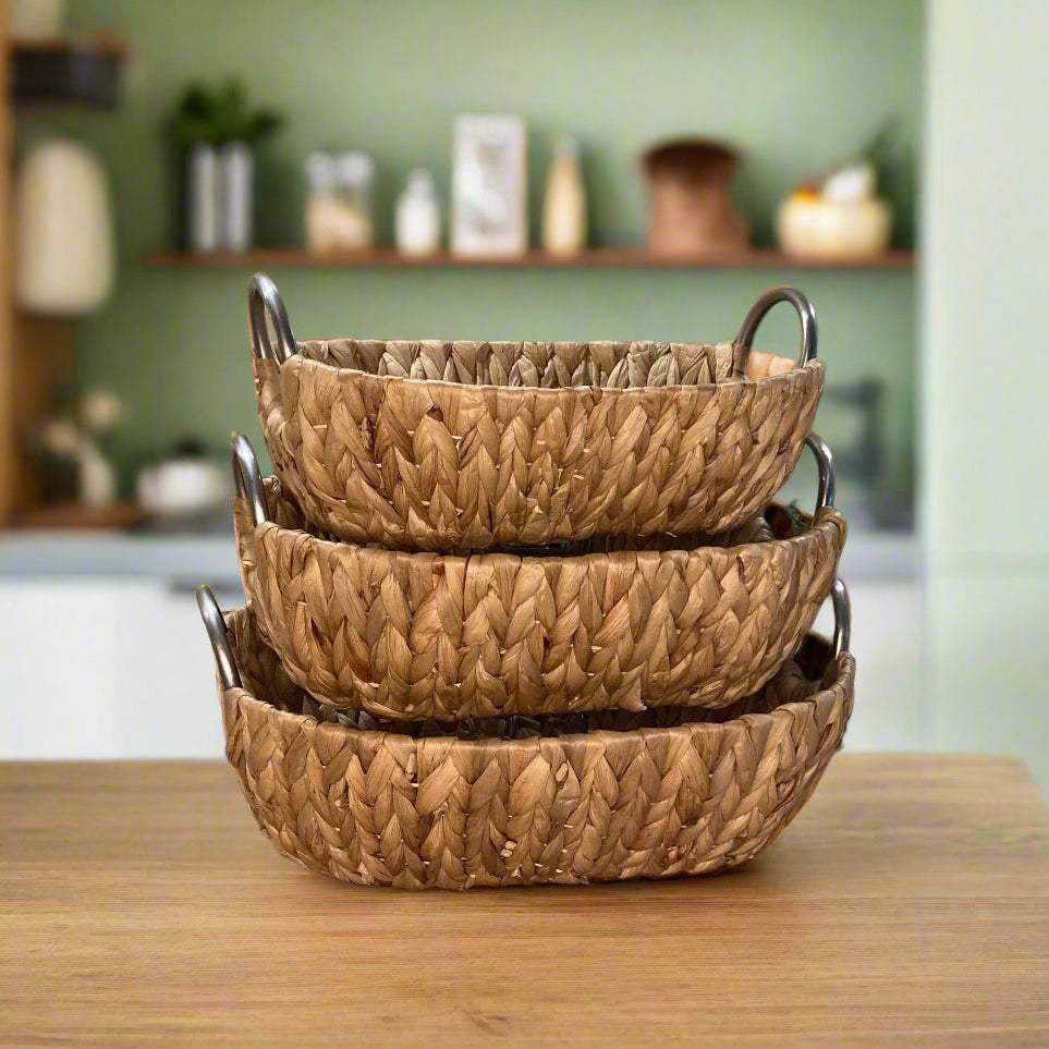 Woven water hyacinth fruit baskets with aluminium loop handles - stacked.
