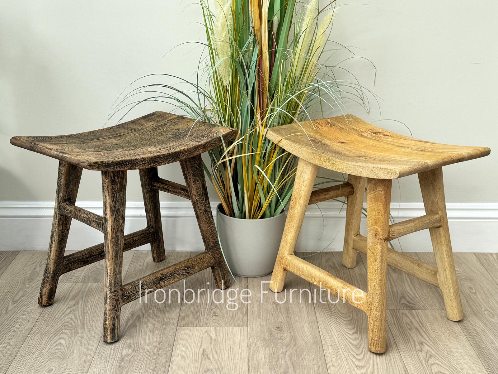 Curved rustic Mango wood stool. Two stools placed side by side. 