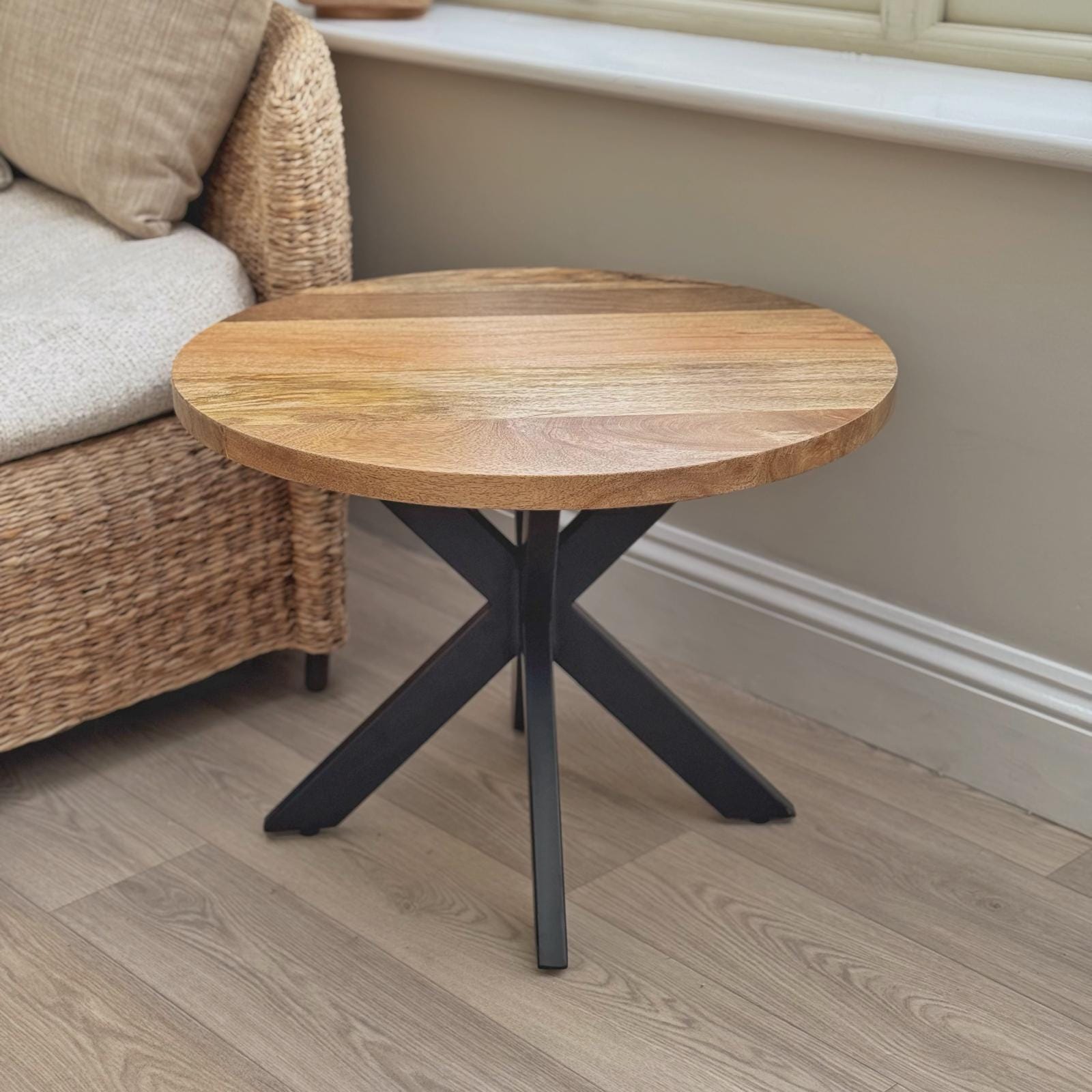 60cm round Mango wood top coffee table with black metal legs. From the front.