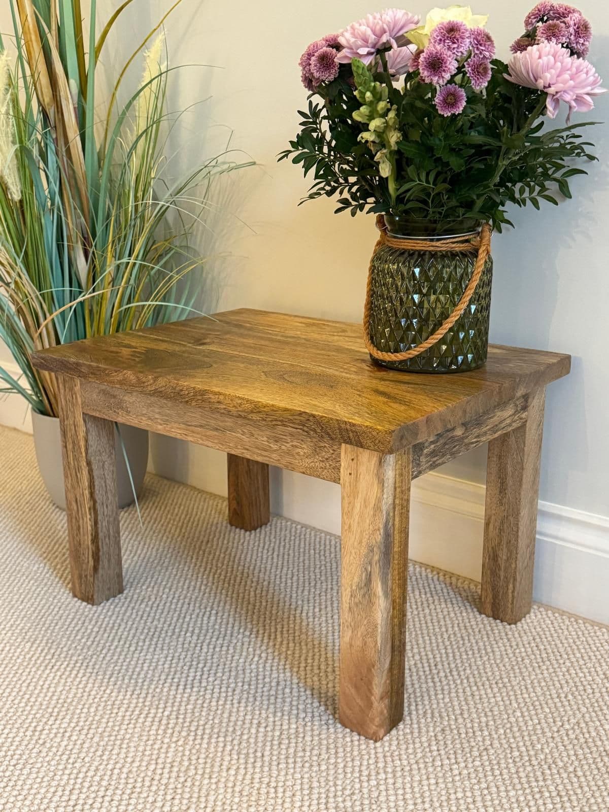 Pair of square finish Mango wood coffee tables larger of the two at an angle