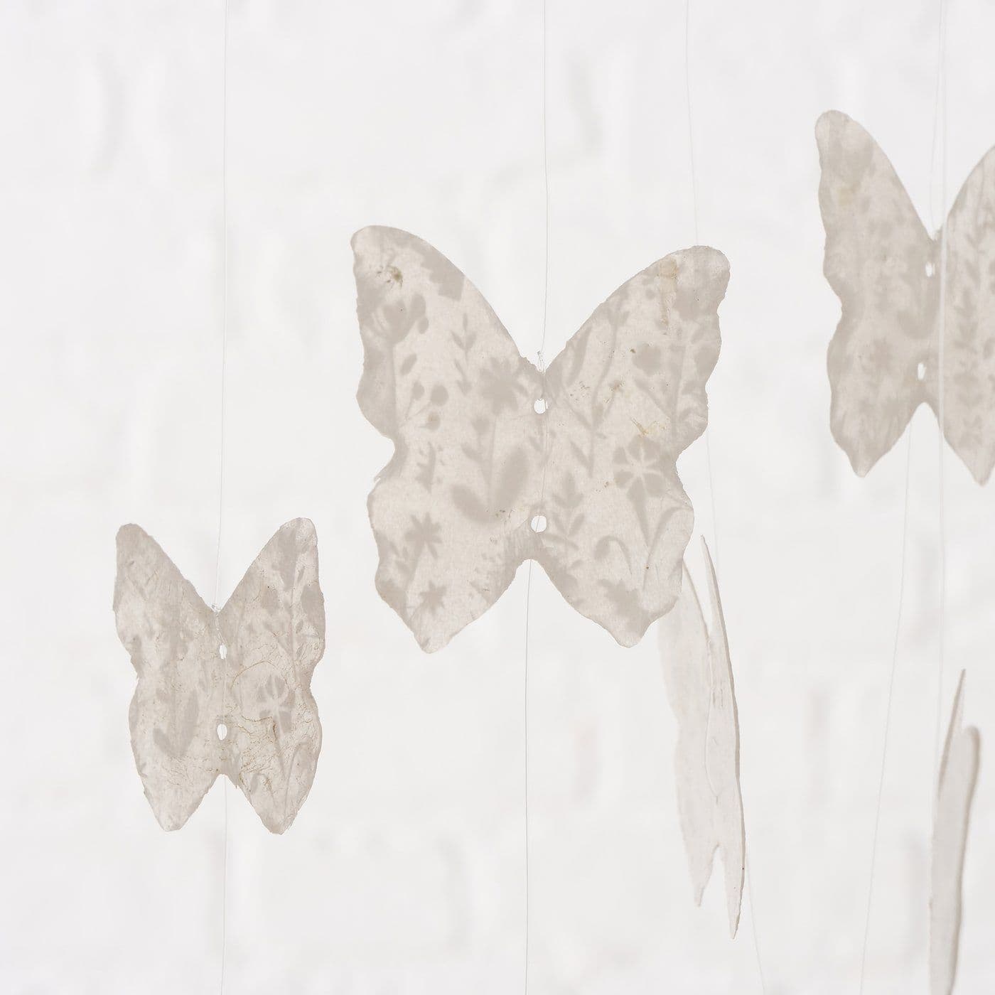 Natural Capiz shell wind chime Butterfly design - white. Close up of butterfly. 