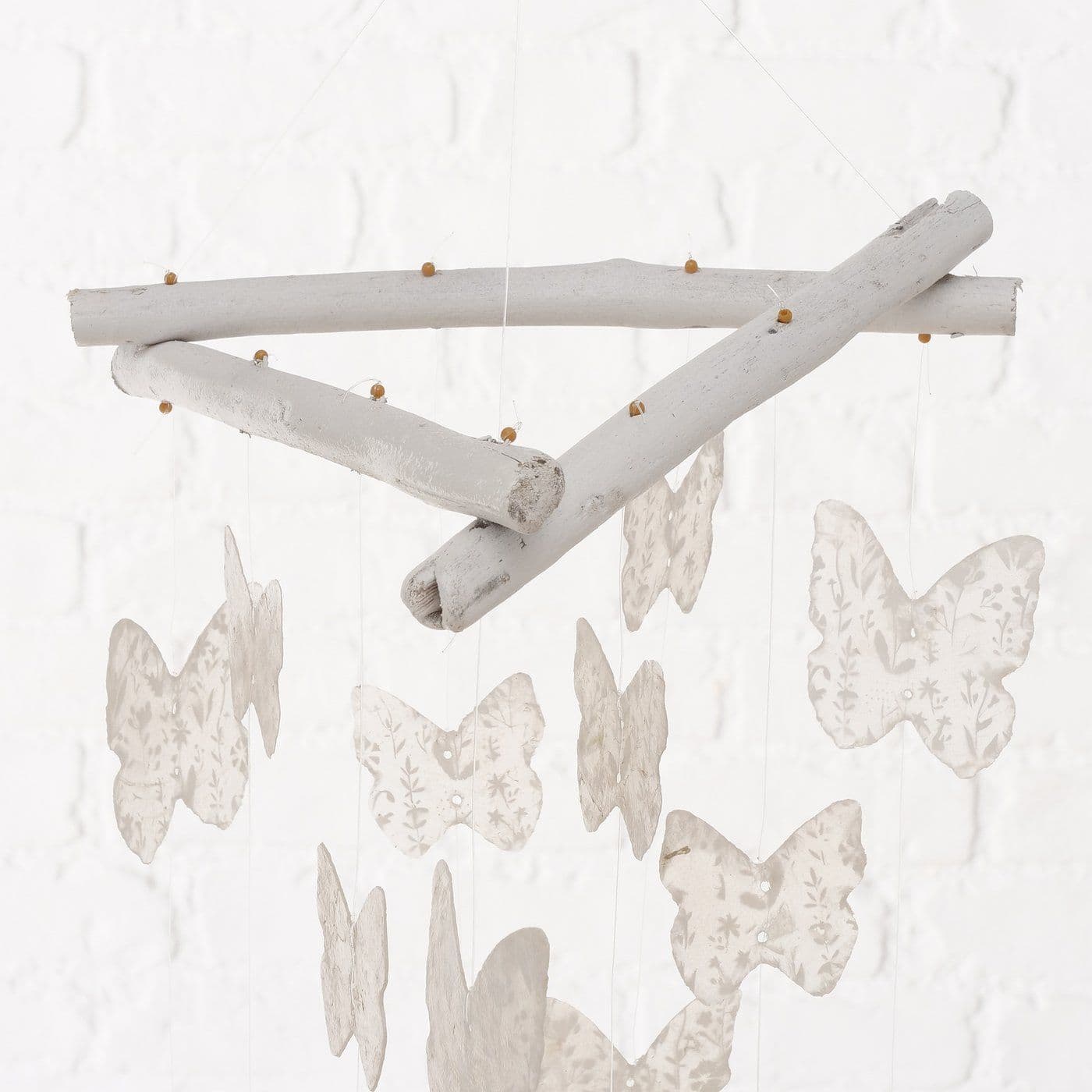 Natural Capiz shell wind chime Butterfly design - white. Close up of holder. 