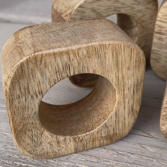 Set of solid Mango wood napkin rings. Video.