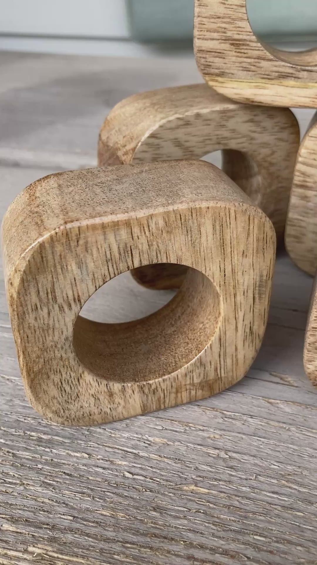 Set of solid Mango wood napkin rings. Video.