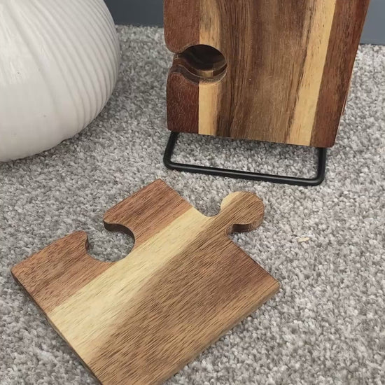 Set of 6 Acacia wood puzzle shaped coasters on a metal holder video.