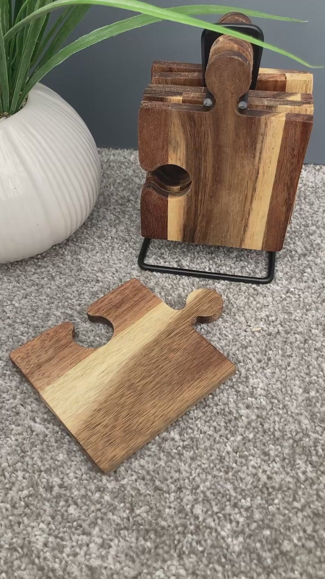 Set of 6 Acacia wood puzzle shaped coasters on a metal holder video.