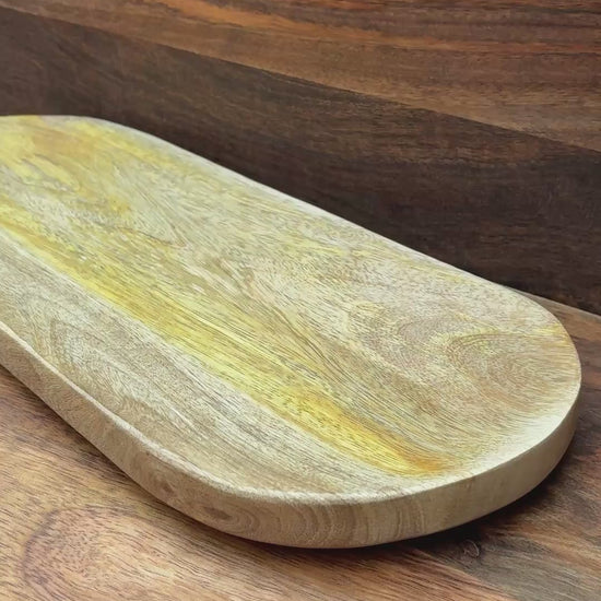 oval mango wood bread dish on wood board