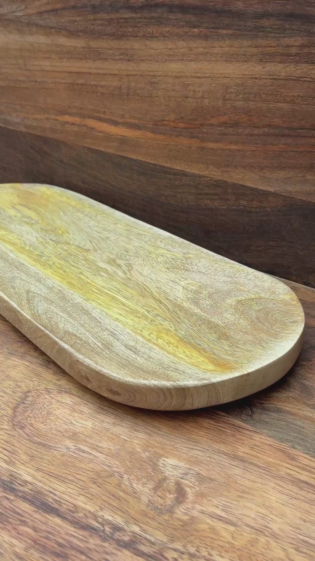 oval mango wood bread dish on wood board