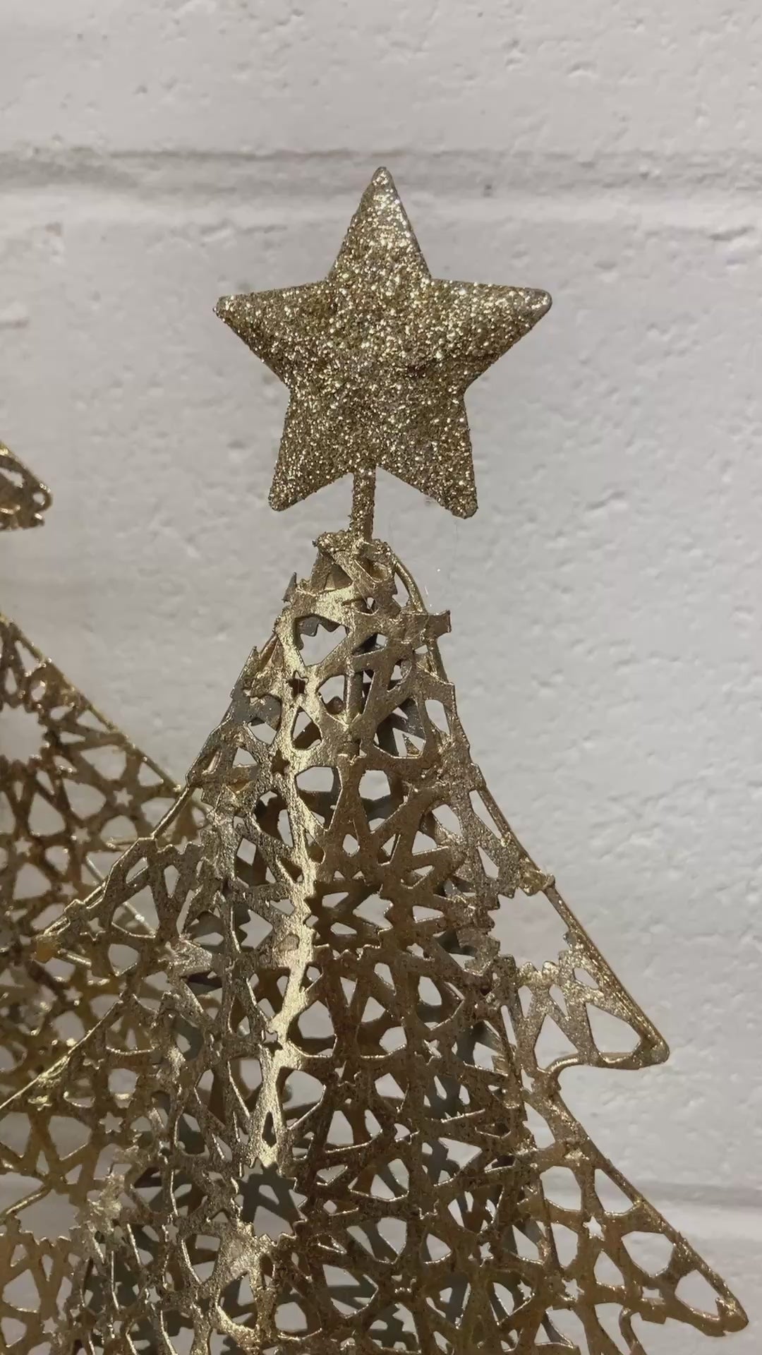 Gold metal Christmas tree on wood log base - video.
